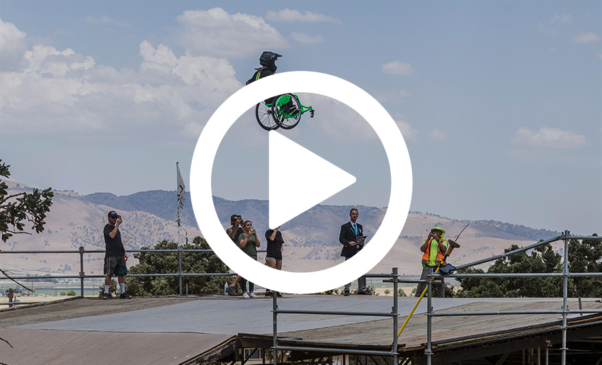 man in wheelchair going over ramp