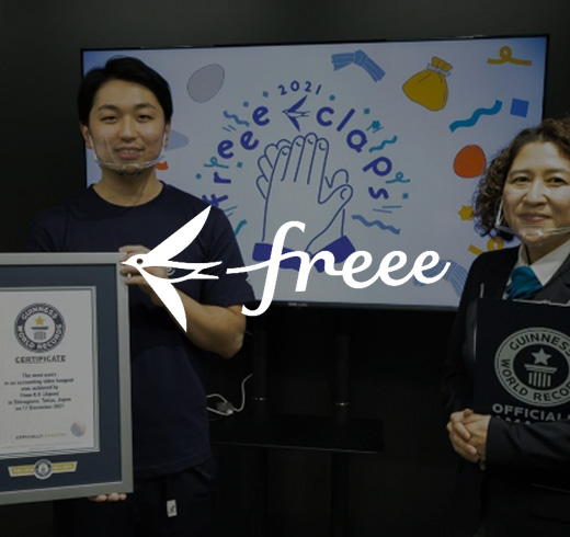freee - man and woman holding gwr certificate next to adjudicator