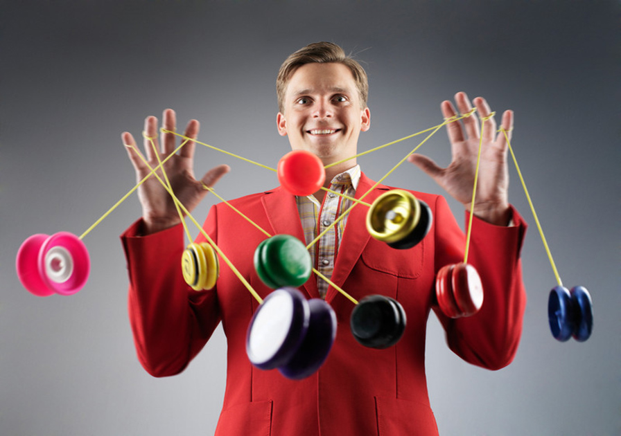 Man using many yoyo's at once