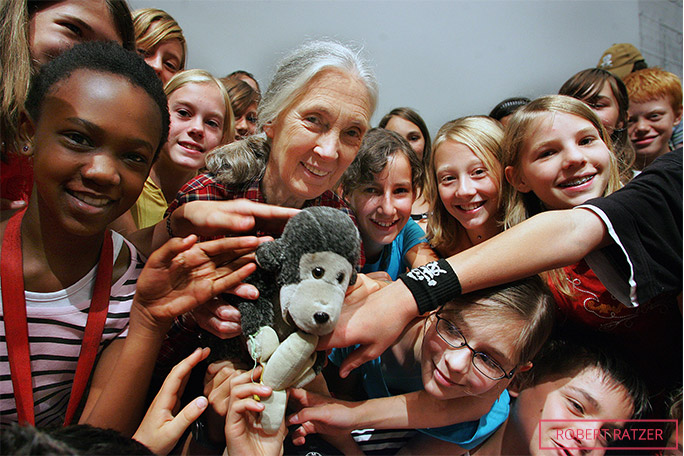 Jane with members of the Roots & Shoots programme, and her famous stuffed-toy travelling companion, Mr H