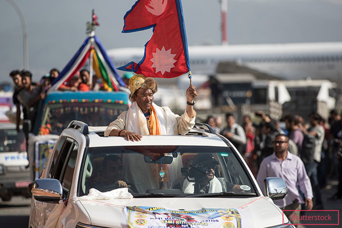 Kami Flying the Nepali flag during a procession in the country's capital, after his 24th ascent of Everest