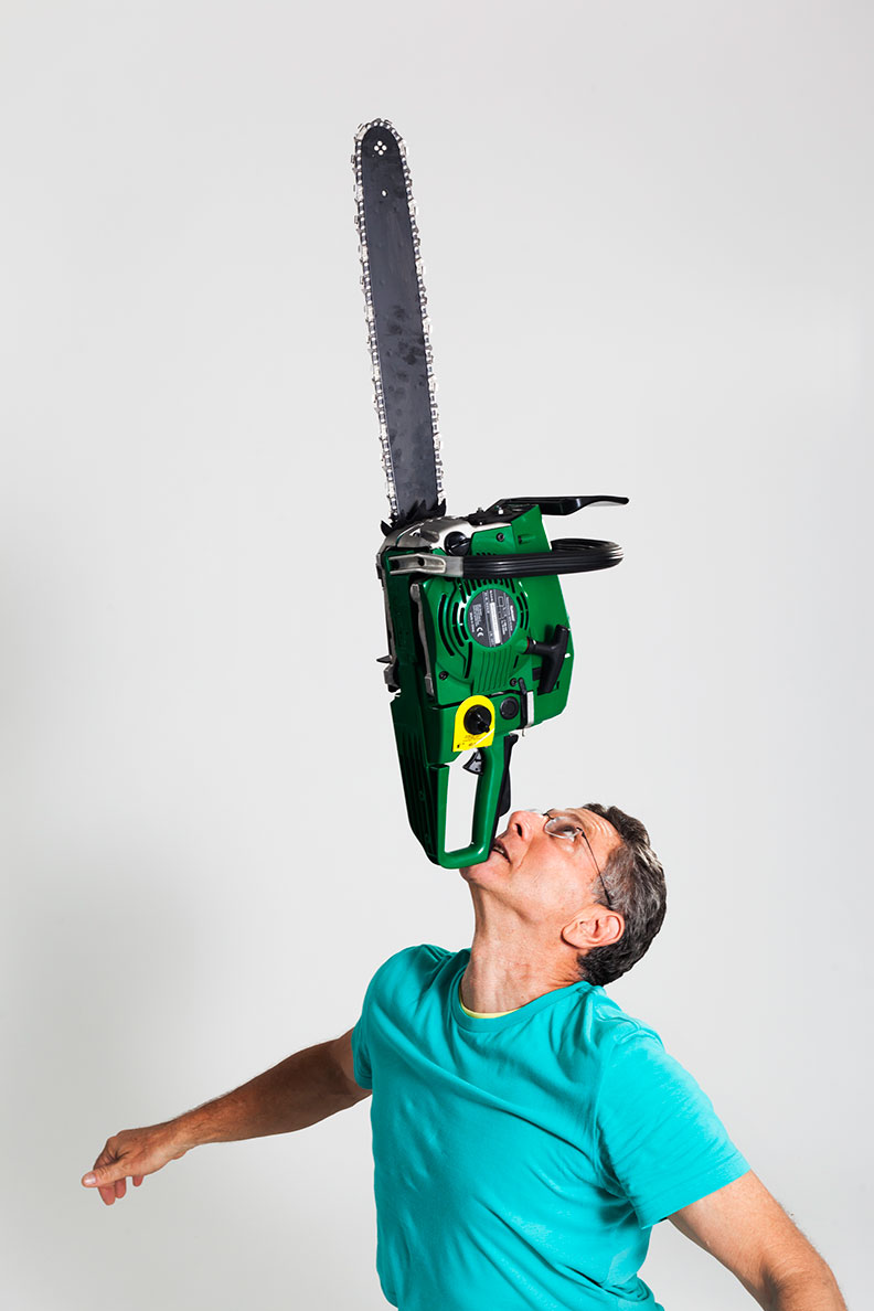 Ashrita achieving the longest duration balancing a chainsaw on the chin, 2013