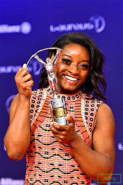 Simone holding her third Laureus World Sports Award