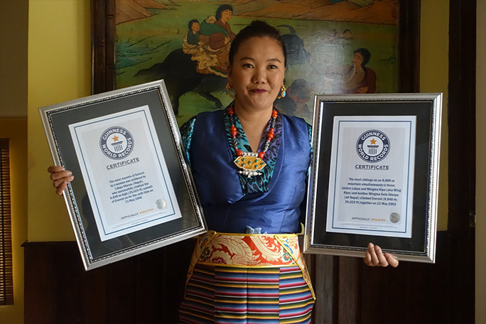 Lhakpa holding two of her GWR certificates