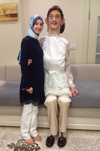 Rumeysa sitting down next to teenager