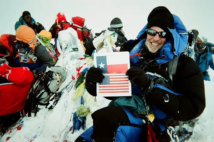 Victor waves his Texas state flag on the summit of Everest