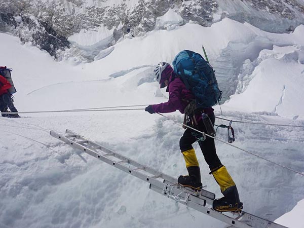 Viridiana on a ladder going down a mountain